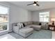 Bright living room with a large sectional sofa, cozy area rug, and abundant natural light at 2803 Tech Dr, Orlando, FL 32817