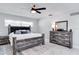 Main bedroom featuring a ceiling fan, natural light, dresser, and nightstands at 2803 Tech Dr, Orlando, FL 32817