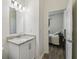 Clean bathroom featuring a granite countertop and sink, with a view into a cozy bedroom at 292 Spirit Landings Cir, Winter Haven, FL 33880