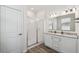 Well-lit bathroom featuring double sinks, granite countertops, a glass-enclosed shower, and wood-look flooring at 292 Spirit Landings Cir, Winter Haven, FL 33880