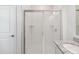 Shower stall featuring white tiles and sliding glass doors plus granite countertop and a white vessel sink at 292 Spirit Landings Cir, Winter Haven, FL 33880