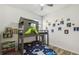Fun bedroom with unique bunk bed, themed decor, and wood look flooring at 292 Spirit Landings Cir, Winter Haven, FL 33880