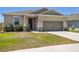 Charming single-story home featuring a two-car garage, manicured lawn, and well-maintained landscaping at 292 Spirit Landings Cir, Winter Haven, FL 33880