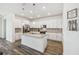 Stylish kitchen with white cabinetry, granite countertops, stainless steel appliances, and center island for entertaining at 292 Spirit Landings Cir, Winter Haven, FL 33880
