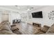 Bright living room featuring an entertainment area, open-concept dining, and lots of natural light at 292 Spirit Landings Cir, Winter Haven, FL 33880
