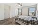 Serene bedroom showcasing a plush bed, wood-look flooring, and natural light streaming through multiple windows at 292 Spirit Landings Cir, Winter Haven, FL 33880