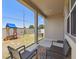 Covered patio with outdoor seating overlooks the backyard's play set and fenced yard at 292 Spirit Landings Cir, Winter Haven, FL 33880
