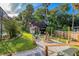 Backyard features an outdoor fire pit area with lush landscaping and comfortable Adirondack chairs at 302 Hermits Trl, Altamonte Springs, FL 32701