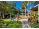 A backyard featuring a cozy fire pit area surrounded by lush landscaping and ample seating at 302 Hermits Trl, Altamonte Springs, FL 32701