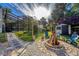 Backyard fire pit area with white rock and lush green landscaping in a serene setting at 302 Hermits Trl, Altamonte Springs, FL 32701