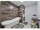 Modern bathroom featuring rustic wood paneling, a freestanding tub, and a stacked washer and dryer at 302 Hermits Trl, Altamonte Springs, FL 32701