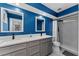 Renovated bathroom with double vanity, modern fixtures, neutral cabinets and walk-in shower at 302 Hermits Trl, Altamonte Springs, FL 32701