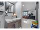 Stylish bathroom with a modern sink vanity area adjoining a Gathering room with hardwood floors at 302 Hermits Trl, Altamonte Springs, FL 32701