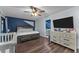 Bedroom featuring hardwood floors, a ceiling fan, an adjacent bathroom and a spacious layout at 302 Hermits Trl, Altamonte Springs, FL 32701