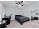 Comfortable bedroom setup with a ceiling fan, desk, and a full-length mirror at 302 Hermits Trl, Altamonte Springs, FL 32701