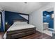 Well-lit bedroom with hardwood floors and an en-suite bathroom at 302 Hermits Trl, Altamonte Springs, FL 32701