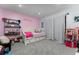 Light and airy bedroom with pink accent wall, plush carpet, and whimsical decor at 302 Hermits Trl, Altamonte Springs, FL 32701