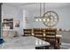 Bright dining room features a marble kitchen island and a rustic dining table at 302 Hermits Trl, Altamonte Springs, FL 32701