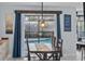 Bright dining area features a wooden table, and a view of backyard pool through sliding doors at 302 Hermits Trl, Altamonte Springs, FL 32701