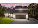 Inviting two-story home featuring a two-car garage and a well-maintained lawn at 302 Hermits Trl, Altamonte Springs, FL 32701