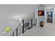 Bright hallway with modern railing overlooking a living area, illuminated by pendant lights at 302 Hermits Trl, Altamonte Springs, FL 32701