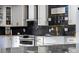 Close-up of the modern kitchen featuring a white farmhouse sink and black backsplash at 302 Hermits Trl, Altamonte Springs, FL 32701