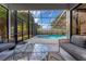 A screened pool with comfortable outdoor seating, with lush landscaping and natural light at 302 Hermits Trl, Altamonte Springs, FL 32701