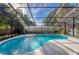 Screened-in pool featuring sunny skies, a custom shape, and privacy wall at 302 Hermits Trl, Altamonte Springs, FL 32701