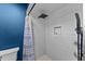 Modern shower featuring sleek tile, rainfall showerhead, built-in niche, and decorative shower curtain at 302 Hermits Trl, Altamonte Springs, FL 32701