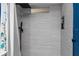 Spa-like shower featuring sleek tile, rainfall showerhead, built-in niche, and blue accent wall at 302 Hermits Trl, Altamonte Springs, FL 32701