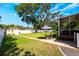 Spacious backyard with lush grass, a stone pathway, and a screened-in porch perfect for relaxing and entertaining at 306 Albany Ave, Deland, FL 32724