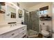 Bright bathroom featuring a glass-enclosed shower, white vanity, designer mirror and fixtures, with ample natural light at 306 Albany Ave, Deland, FL 32724