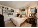Cozy bedroom filled with natural light, complemented by calming decor, soft bedding, and hardwood flooring at 306 Albany Ave, Deland, FL 32724