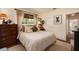 Comfortable bedroom with stylish curtains, wood blinds, calming decor, soft bedding, and hardwood flooring at 306 Albany Ave, Deland, FL 32724