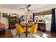 Cozy dining room with a round table, yellow chairs, and a decorative display cabinet at 306 Albany Ave, Deland, FL 32724
