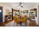 Bright dining room with a fireplace, bookshelves, and a round table with yellow chairs at 306 Albany Ave, Deland, FL 32724