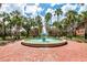 Beautiful fountain in a park-like setting surrounded by palm trees and brick walkways at 306 Albany Ave, Deland, FL 32724