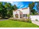 Charming home exterior with manicured lawn, beautiful plants and inviting front porch at 306 Albany Ave, Deland, FL 32724