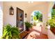Inviting front porch with potted plants, sconces, and a decorative archway at 306 Albany Ave, Deland, FL 32724