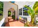 Inviting front porch with colorful bench, plants, and textured walls at 306 Albany Ave, Deland, FL 32724