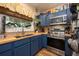 Updated kitchen featuring blue cabinets, butcher block counters, and stainless steel appliances at 306 Albany Ave, Deland, FL 32724