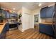 Inviting kitchen featuring blue cabinets, butcher block countertops, stainless steel appliances, and decorative backsplash at 306 Albany Ave, Deland, FL 32724