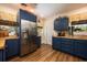 Stylish kitchen with blue cabinets, butcher block countertops, and stainless steel appliances at 306 Albany Ave, Deland, FL 32724