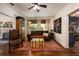 Inviting living room with a leather couch, decorative trunk, and a fireplace at 306 Albany Ave, Deland, FL 32724