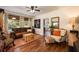Cozy living room with a leather sofa, patterned rug, and a view into the kitchen at 306 Albany Ave, Deland, FL 32724