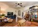 Comfortable living room with a large TV, built-in shelving, and a view into the dining area at 306 Albany Ave, Deland, FL 32724