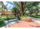 Sculpture on a bench with trees and green foliage in a park-like setting at 306 Albany Ave, Deland, FL 32724