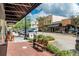 Commercial street view with shops and parked vehicles under a cloudy sky at 306 Albany Ave, Deland, FL 32724