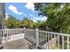Outdoor deck features white railings, scenic views and a glimpse of the backyard at 32615 Windy Oak St, Sorrento, FL 32776