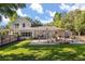 Spacious backyard featuring a fire pit with seating, a wooden deck, and mature trees for privacy at 32615 Windy Oak St, Sorrento, FL 32776